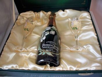 A bottle of Perrier Jouet 1998 Anniversary Gift champagne and two champagne flutes in a box.