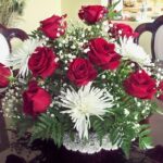 Red roses and white baby's breath in an Arrangement, R8.