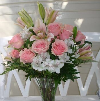 Sweet Pink, A Bouquet for Mom roses and white lilies in a clear vase.