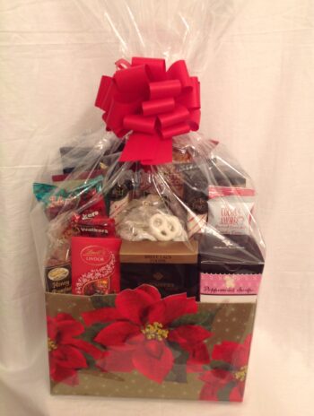 A delightful Holiday Greetings gift basket adorned with a beautiful poinsettia, perfect for corporate clients during the Christmas season.