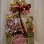 A Pink Peonies Gift Basket with a pink ribbon.