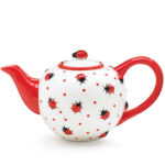 A Lady Bug Teapot on a white background.