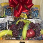 A wicker basket filled with fresh fruit and Healthy Snacks for the office, available for free shipping.